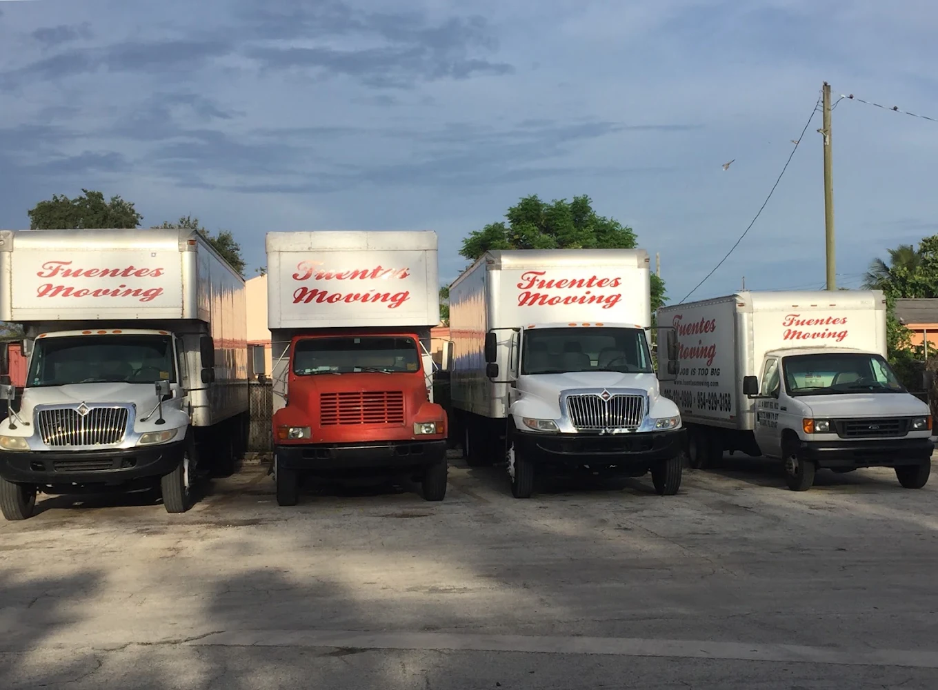 Four Fuentes Moving trucks parked together