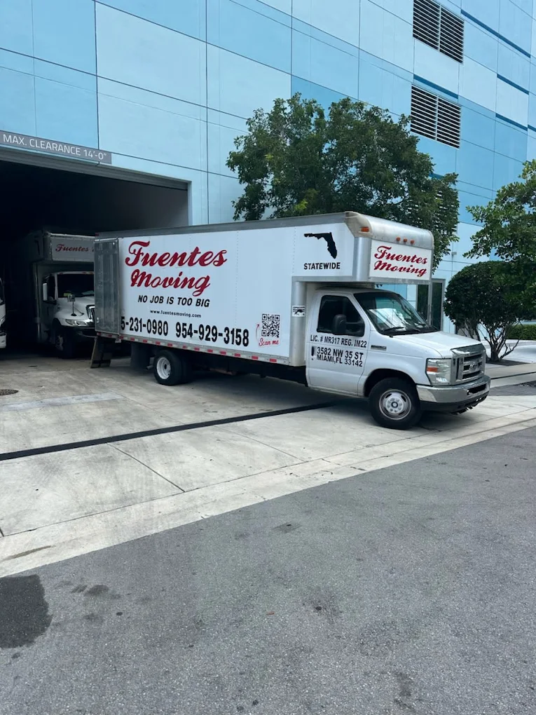 A Fuentes Moving truck parked at a South Florida property
